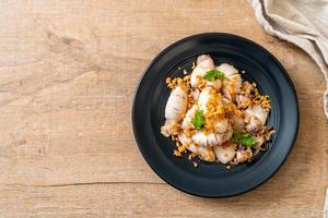 Fried squid or octopus with garlic on plate photo