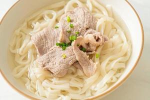 Homemade udon ramen noodles with pork in clear soup