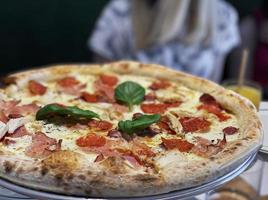 Pizza with pizza sauce, mozzarella cheese and pepperoni. photo