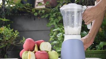 Making Fresh Apple and Guava Juice with An Electric Blender.