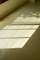 Beautiful sunlight and sun-blind shadow on floor photo