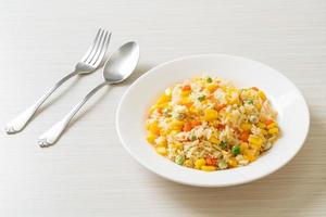 Homemade fried rice with mixed vegetables of carrot, green bean peas, corn, and egg photo