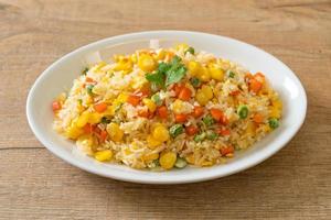 Homemade fried rice with mixed vegetables of carrot, green bean peas, corn, and egg photo