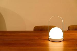 Beautiful lamp with lighting on table with copy space photo