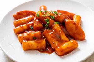 Korean rice cake stick with sausage in spicy sauce - Tteokbokki photo