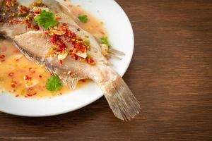 Steamed grouper fish with lime and chillies photo