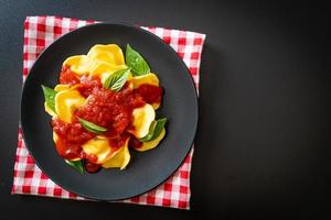 Ravioli with tomato sauce and basil photo