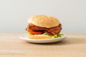 Grilled chicken burger with sauce on white plate photo