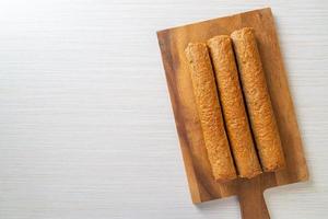 Fried Chinese fish cake or fish ball line on wood board photo