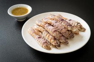 Steamed crayfish or mantis shrimps or stomatopods with spicy seafood sauce photo