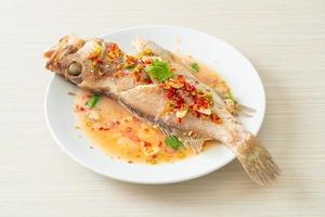 Steamed grouper fish with lime and chillies photo