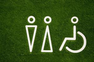 Toilet sign for men and women with disabilities on the green grass