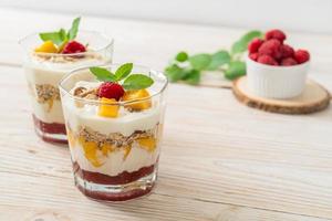 Homemade fresh mango and fresh raspberry with yogurt and granola - healthy food style photo