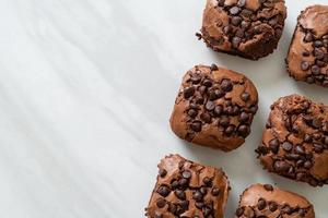 Dark chocolate brownies with chocolate chips on top photo