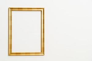Empty picture frame on white wall background with copy space