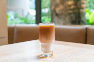 Iced latte coffee glass in coffee shop cafe and restaurant photo