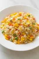 Homemade fried rice with mixed vegetables of carrot, green bean peas, corn, and egg photo