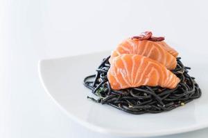 Spicy black spaghetti with salmon - fusion food style photo