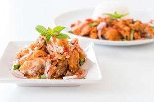 Spicy salad with fried chicken with rice photo