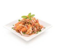 Spicy salad with fried chicken with rice photo