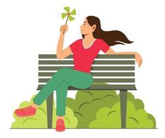 mujer disfruta del molino de viento de papel mientras está sentada en un banco en el jardín. vector