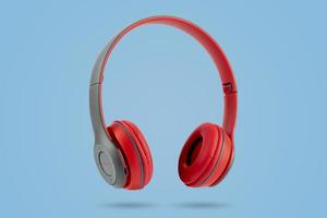 Red color wireless earphones on blue pastel color background photo