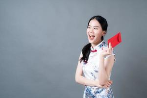 Asian woman wear Chinese traditional dress with red envelope or red packet photo