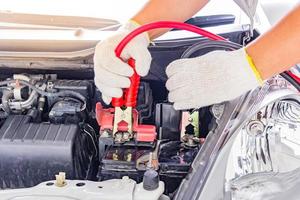 Charging car battery with electricity trough jumper cables photo