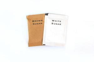 white and brown sugar bag on white background photo