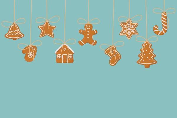 Hanging gingerbread cookies on blue background. Christmas template