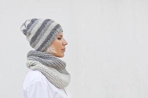 Young woman in warm grey knitted hat and snood photo