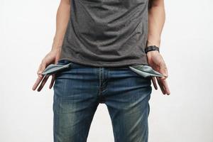 Man turning out the jean pocket to showing empty pocket. no money. photo