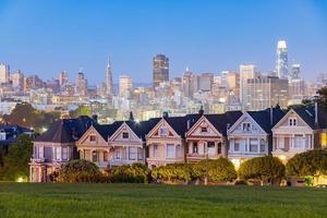 The famous Painted Ladies with the skyline of San Francisco, California, USA