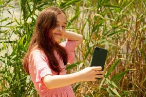 A young girl makes a selfie photo