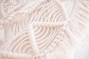 Handmade macrame pattern a fragment of a wall panel in the boho style photo