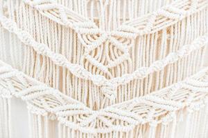 Handmade macrame pattern a fragment of a wall panel in the boho style photo