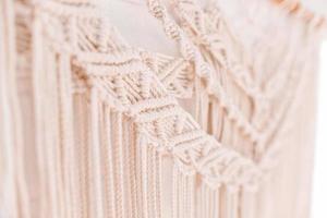 Handmade macrame pattern a fragment of a wall panel in the boho style photo