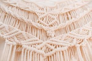 Handmade macrame pattern a fragment of a wall panel in the boho style photo