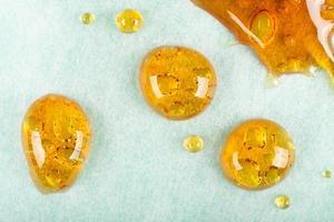 Golden drops of cannabis wax macro closeup photo