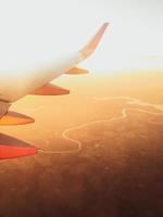 Hazy airplane wing view sunny cinematic panorama photo