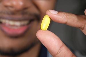 Close up of man hand holding pills photo