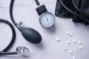 top view of blood pressure machine and medical pill on table . photo