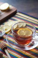 lemon tea and honey on wooden background. photo