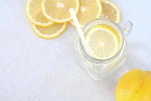 Refreshing lemon water drink on table , top view photo