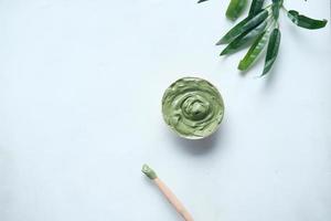 bubble clay mask in container on white background photo