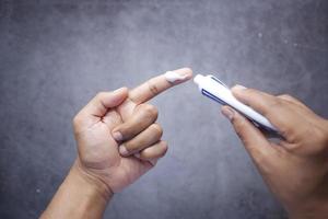 Man applying antibiotic cream top view photo