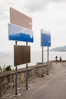 Blank blue and brown street signs along the seaside road photo