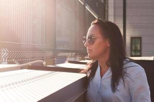 beautiful brunette looks at the sunset, close-up photo