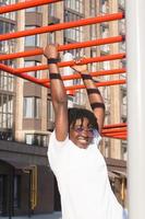 portrait of a happy African-American woman on the street in summer photo