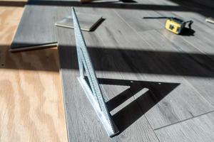 man installing engineered laminate wood floring indoor photo